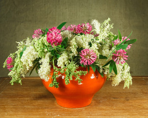 Still life. Bouquet of meadow flowers in white pots