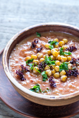 Bowl of chickpea soup on the wooden table