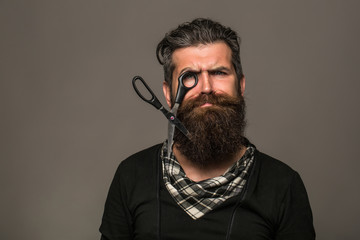bearded man with hairdresser scissors