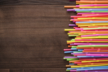 colorful striped bendy cocktail straws on wooden table