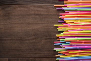 Fototapeta premium colorful striped bendy cocktail straws on wooden table