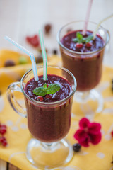 Fragrant refreshing berry smoothie in glass wine glasses with mint