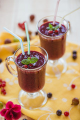 Fragrant refreshing berry smoothie in glass wine glasses with mint