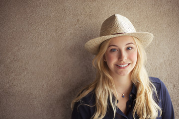 Portrait of blonde woman with straw hat