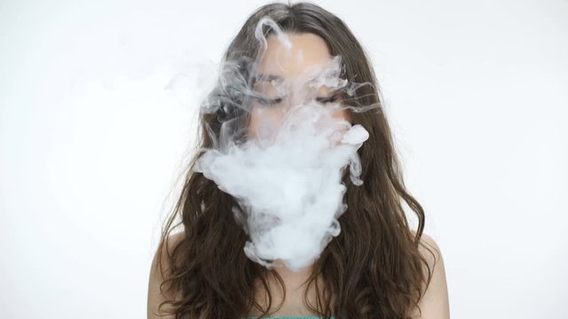 Young beautiful woman smoking electronic cigarette, hookah