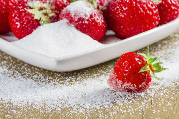 Ripe strawberry in sugar closeup