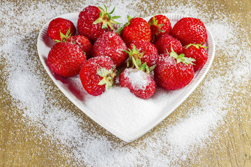 Ripe strawberry in sugar closeup