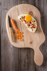 scrambled eggs with bread on cutting board