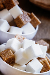 Pieces of white and brown sugar, selective focus