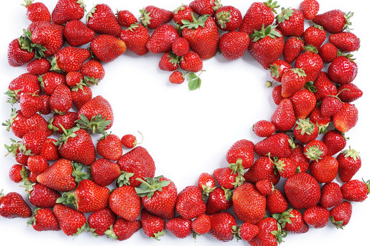 Heart made from Strawberry on white background. Copy space. Top view, High resolution product.