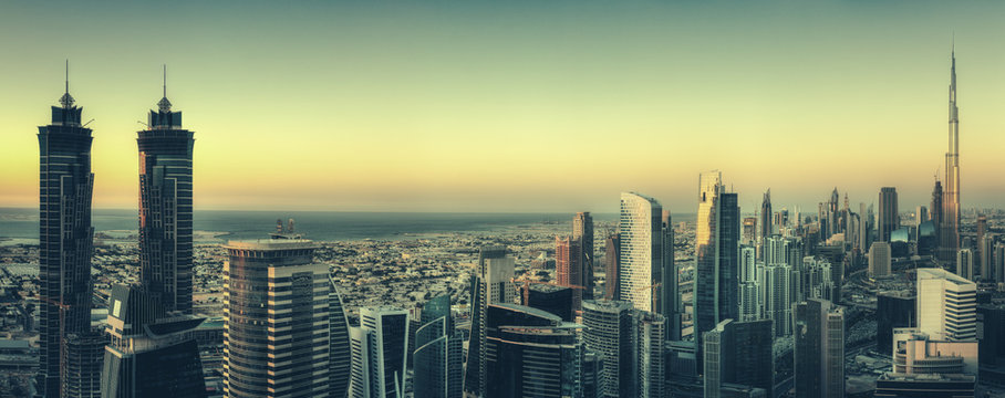 Scenic panoramic view of Dubai modern architecture at sunset. Aerial skyline with downtown skyscrapers. © Funny Studio