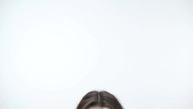 Young beautiful woman with surprised look playing hide and seek