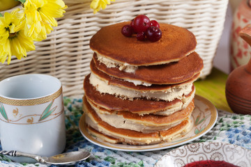 Pancake cake with cream on a plate Still cranberry