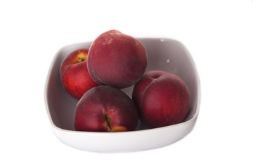 peaches in white dish isolated