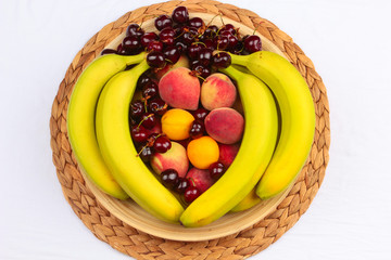 Wooden Bowl of Fruits / A Wooden Bowl of Fruits on a Wooden Background, Banana & Cherries