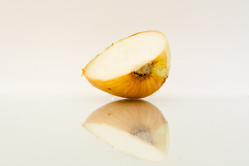 Half of bulb onion with reflection on white background