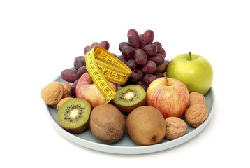 A measure tape on top of fresh fruit