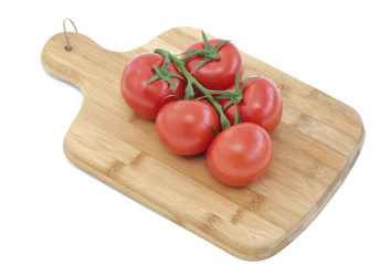 Tomatoes on a wooden cutting board