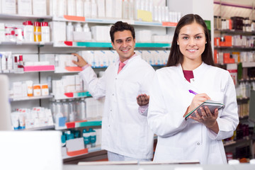 Portrait of two friendly pharmacists working