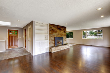 Large empty living room with fireplace