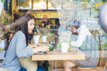 Beautiful smiling and young asian women drinking a coffee at cof