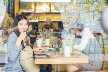 Beautiful smiling and young asian women drinking a coffee at cof