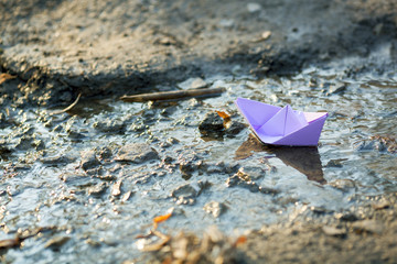 Blue paper boat in water
