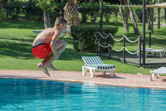 Teen Boy Dives And Swims In The Pool