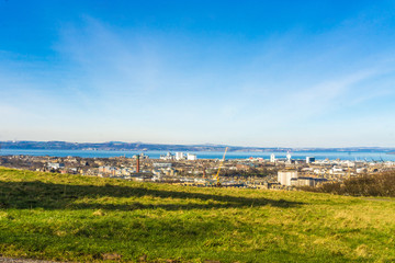 Fototapeta na wymiar Edinburgh Cityscape from Calton Hill blue sky Scotland UK