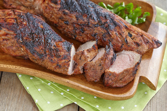 Grilled pork tenderloin served with greenery