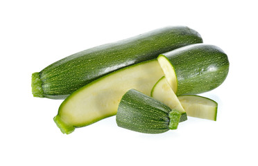 whole and portion cut fresh Zucchini on white background