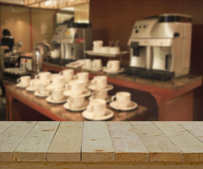 wood table top on blur background of coffee break conner