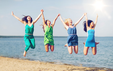 girls jumping on the beach