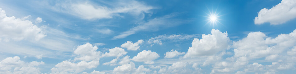 Panorama blue sky with clouds and sun reflection. looking up view