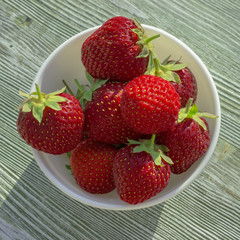 Wooden rustic table with strawberries