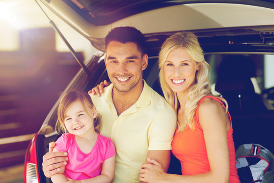 happy family with hatchback car at home parking