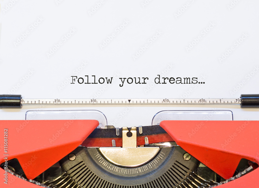 Fototapete close up image of typewriter with paper sheet and the phrase: follow your dreams.