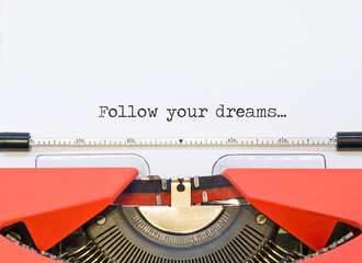 close up image of typewriter with paper sheet and the phrase: Follow your dreams. 