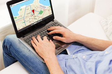 Fototapeta premium close up of man typing on laptop computer at home