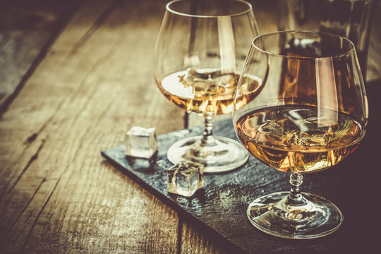 Cognac in glasses on rustic backgrpund