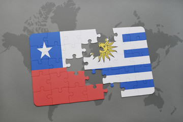 puzzle with the national flag of chile and uruguay on a world map background.