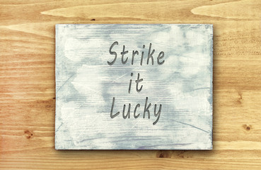 Obraz premium Motivational phrase note, Strike It Lucky sign