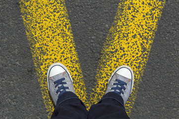 Sneakers standing on the yellow line