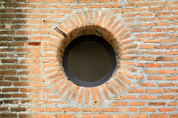 Vintage circular shape window on red brick wall architecture