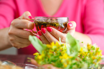 Closeup of female holding a mug. Selective focus on hands and fi