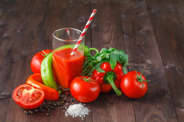 Fresh tomato juice on the rustic table.