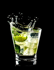 Mojito cocktail on black background with splash