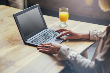 Closeup of female hands using modern laptop in interior, businesswoman working at her office on technology, girl fleelancer working at home on laptop.
