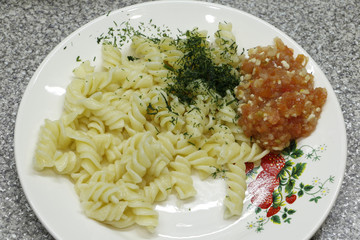 Pasta with additives in a white plate