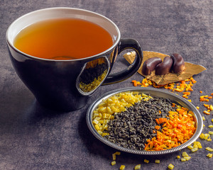 Large cup of hot green tea on a dark background. Scented dry tea